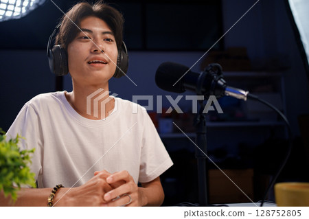 Female podcaster interviewing a guest in a recording studio Female podcaster interviewing a guest in a recording studio 128752805
