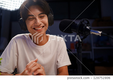 Female podcaster interviewing a guest in a recording studio Female podcaster interviewing a guest in a recording studio 128752806