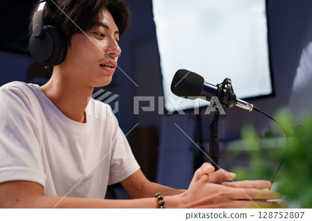 Female podcaster interviewing a guest in a recording studio Female podcaster interviewing a guest in a recording studio 128752807