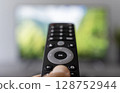 Switching TV Channels with Remote Control 128752944