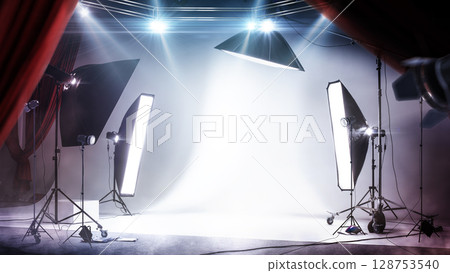 Backstage. Professional lighting. Photo studio background with white backdrop and backlight. Workspace with backdrop, backstage and lamps 128753540