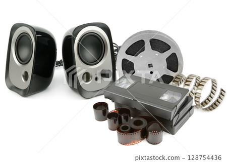 Acoustic music speakers, video cassettes, film and photographic film isolated on white background. Acoustic music speakers, video cassettes, film and photographic film isolated on white background. 128754436