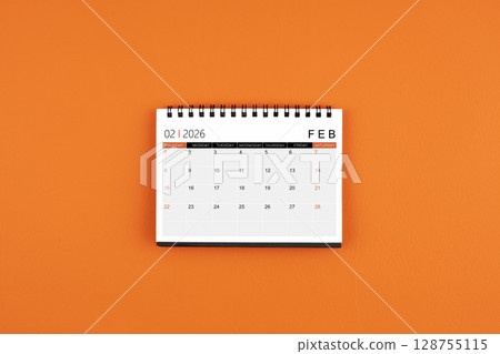 February 2026 Monthly desk calendar on orange color leather background. February 2026 Monthly desk calendar on orange color leather background. 128755115