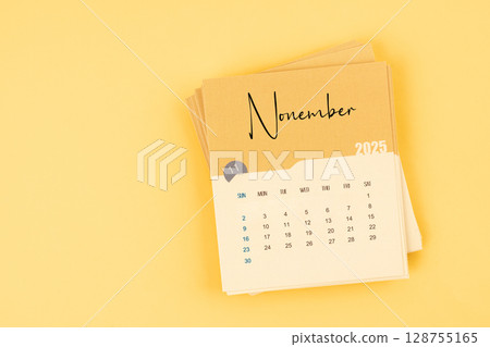 November 2025 calendar card on yellow color background with copy space. 128755165