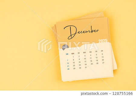 December 2025 calendar card on yellow color background with copy space. December 2025 calendar card on yellow color background with copy space. 128755166