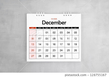 December 2026 desk calendar on gray cement wall background. Page of annual monthly calendar. 128755167