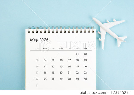 May 2026 calendar and airplane toy on blue color background, Travel plan concepts. May 2026 calendar and airplane toy on blue color background, Travel plan concepts. 128755231