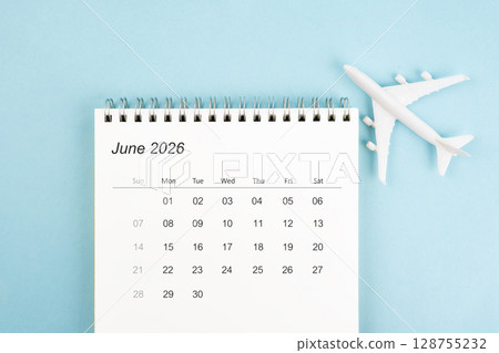 June 2026 calendar and airplane toy on blue color background, Travel plan concepts. 128755232