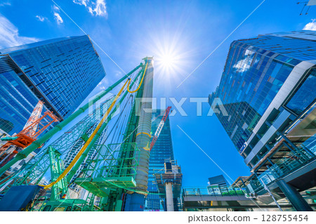 Tokyo cityscape, Japan, July 20th. Extreme heat...huge heavy machinery lined up...goodbye, Shibuya Station West Exit. Full-scale construction begins. 128755454