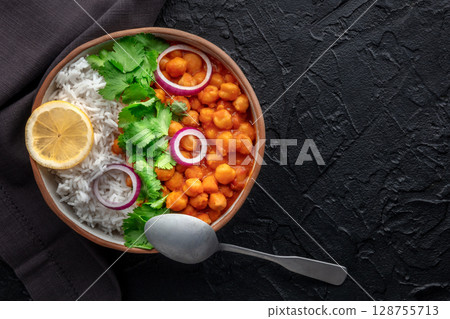 Chana masala, chickpea curry, traditional Indian dish, overhead flat lay shot 128755713