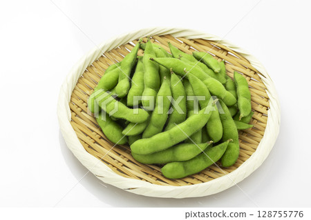 Edamame beans served in a colander on a white background 128755776