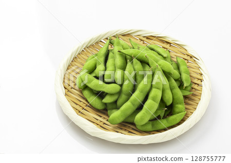 Edamame beans served in a colander on a white background 128755777