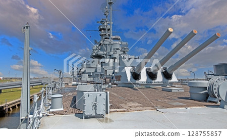 USS Alabama side view with cannons under clouds 128755857