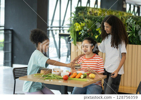group of multi-ethnic children girls are learning how to cooking with miniature kitchen utensils, teamwork student education up skill make food. 128756359