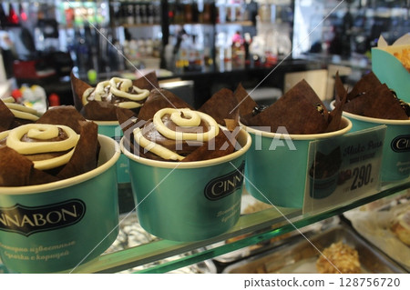 St. Petersburg, Russia, April 01 2024: Cinnabon buns in the window of a cafe at the food court 128756720