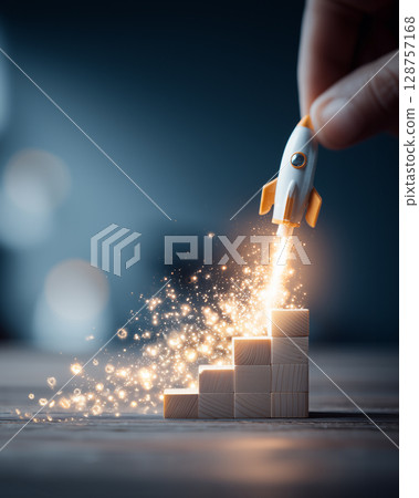 Small Rocket Launching from Stack of Wooden Blocks Representing Growth and Forward Momentum 128757168