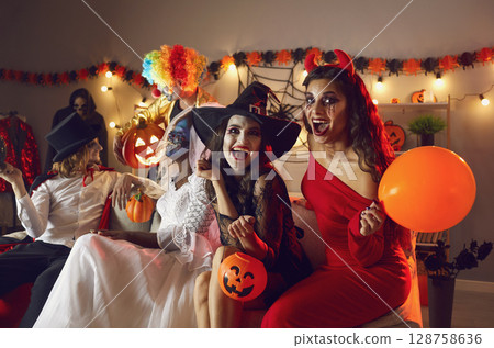 Group of creative and fun friends celebrate Halloween together by having spooky party at home. Group of creative and fun friends celebrate Halloween together by having spooky party at home. 128758636