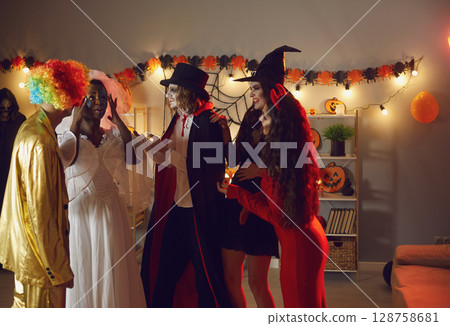 People view image and makeup of their female friend who is dressed as dead bride for Halloween. 128758681