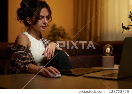 beautiful graphic designer woman working at home office remotely using digital graphic tablet and laptop beautiful graphic designer woman working at home office remotely using digital graphic tablet and laptop 128758739