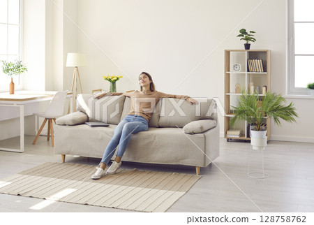 Calm woman relax on sofa taking nap Calm woman relax on sofa taking nap 128758762