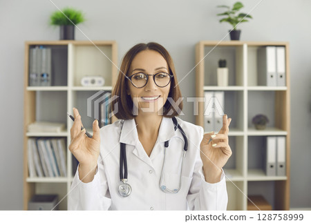 Video conference headshot portrait of happy online doctor looking at camera and talking Video conference headshot portrait of happy online doctor looking at camera and talking 128758999