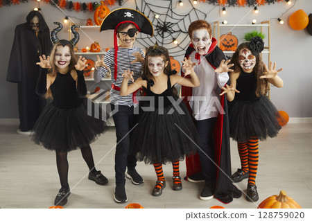 Portrait of group of children in creative costumes with scared faces at Halloween party. 128759020