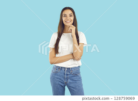 Beautiful young woman thinking keeping hand under her chin Beautiful young woman thinking keeping hand under her chin 128759069