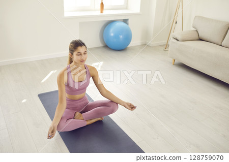 Young woman meditate practice yoga at home Young woman meditate practice yoga at home 128759070