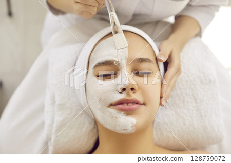 Young woman getting professional cosmetic facial treatment in spa or beauty salon Young woman getting professional cosmetic facial treatment in spa or beauty salon 128759072