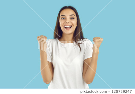 Portrait of happy excited young woman celebrating success, doing yes gesture and smiling Portrait of happy excited young woman celebrating success, doing yes gesture and smiling 128759247