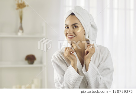 Smiling woman apply patches for fresh look Smiling woman apply patches for fresh look 128759375