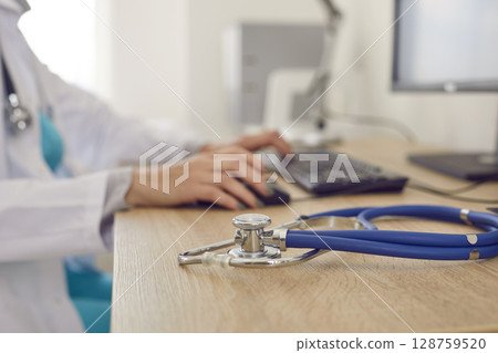 Doctor stethoscope on table in private hospital 128759520