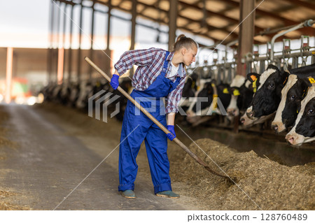Young woman farmer with pitchfork on farm 128760489
