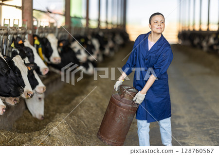 Asian woman employee with metal milk can Asian woman employee with metal milk can 128760567