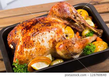Close up of tasty cooked homemade turkey with apples, lemon and greens Close up of tasty cooked homemade turkey with apples, lemon and greens 128760640