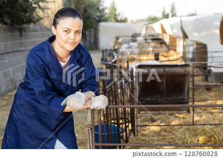 woman farmer standing near the stall woman farmer standing near the stall 128760828