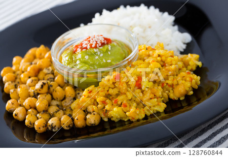 Dish of chickpeas and rice with red and green sauces Dish of chickpeas and rice with red and green sauces 128760844