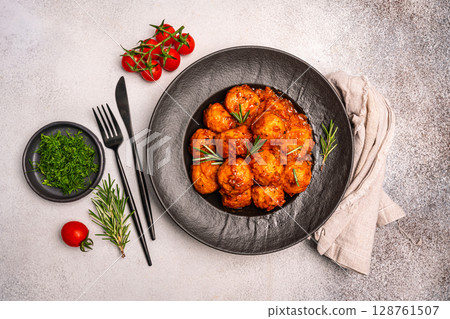 Meatballs with spices and sauce in a plate Meatballs with spices and sauce in a plate 128761507