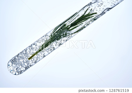 The texture of the serum in a test tube with rosemary. 128761519