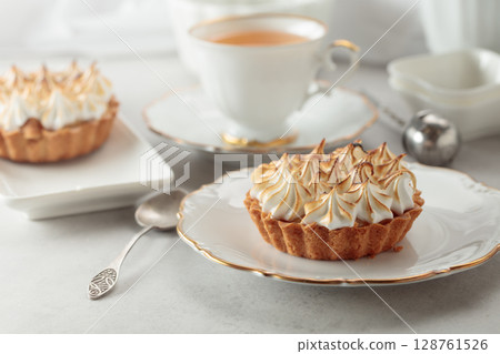 Meringue tart on a white marble countertop. 128761526