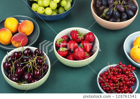 Mix of ripe colorful berries and fruits. 128761541