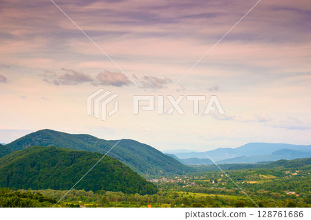 mountain landscape under evening sky with dramatic clouds. beautiful carpathian countryside scenery in summer. picturesque view 128761686