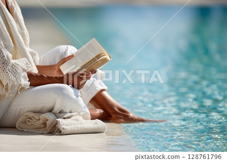 Woman relaxing by the poolside reading a book with serene water reflections and soft sunlight Woman relaxing by the poolside reading a book with serene water reflections and soft sunlight 128761796