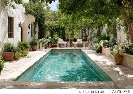 Serene backyard oasis with a sparkling pool surrounded by lush greenery and elegant seating area 128761886