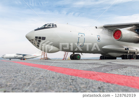 Two white wide body freight transport airplanes at airport 128762019