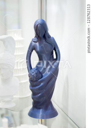 Art object printed on 3D printer. Colored creative model printed on 3D printer from molten ABS PLA plastic filament. Object figurine of woman and child printed on FDM printer. Additive technology, 128762313