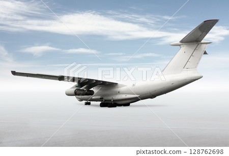 White wide body transport cargo aircraft isolated on bright background with sky 128762698