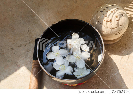 Zen Meditation Setup. A serene scene with a smoke sphere and singing bowl with flowers 128762904