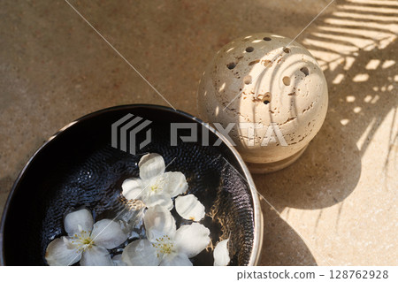 Zen Meditation Setup. A serene scene with a smoke sphere and singing bowl with flowers 128762928
