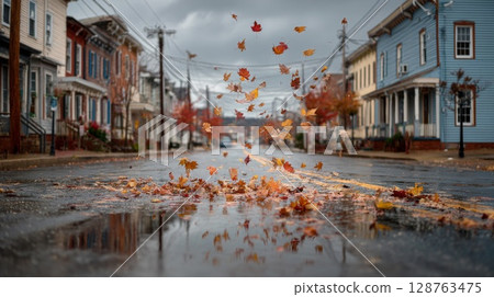 Autumn Leaves Falling on a Wet City Street 128763475